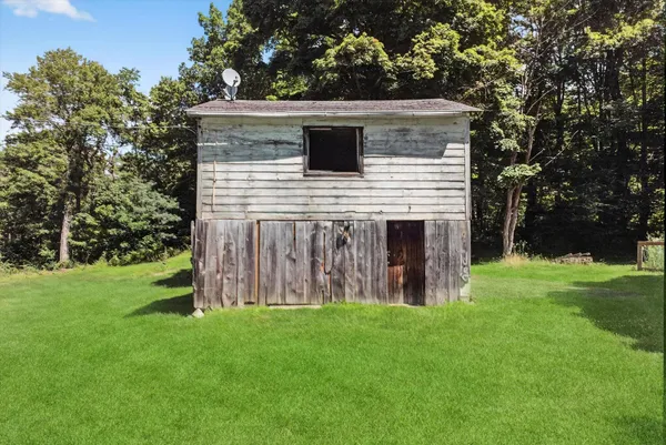 a view of backyard of house with green space