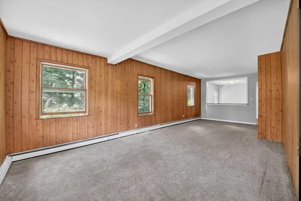 an empty room with windows and closet