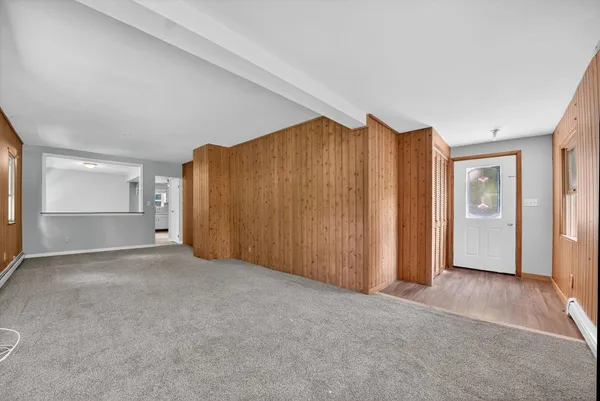 an empty room with closet and a cabinet