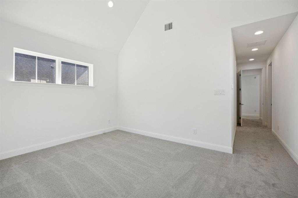 9620 Mav Lane Dallas, TX 75238 - Photo 7 of 11 Unfurnished room with light carpet, recessed lighting, and vaulted ceiling