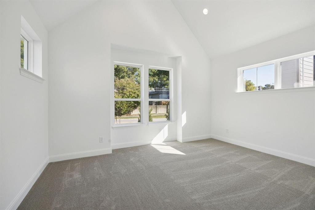 9620 Mav Lane Dallas, TX 75238 - Photo 8 of 11 Unfurnished room featuring plenty of natural light, dark carpet, lofted ceiling, and recessed lighting