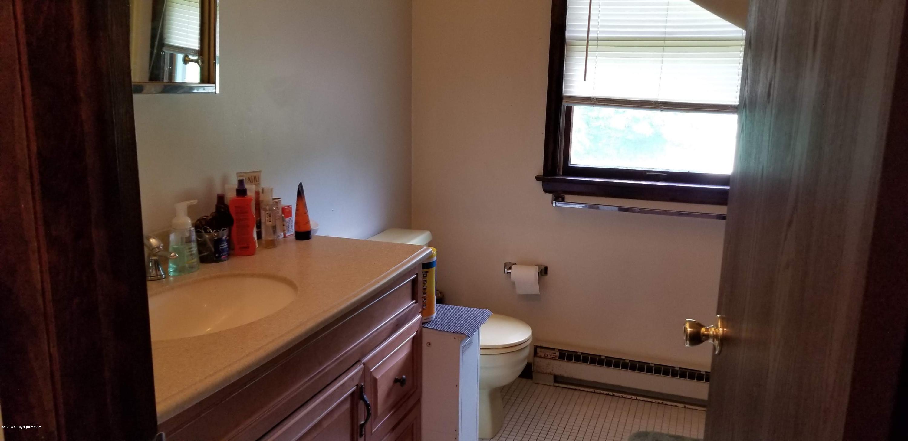 3401 Walnut Road Kunkletown, PA 18058 - Photo 15 of 25 a bathroom with a sink toilet vanity and a window