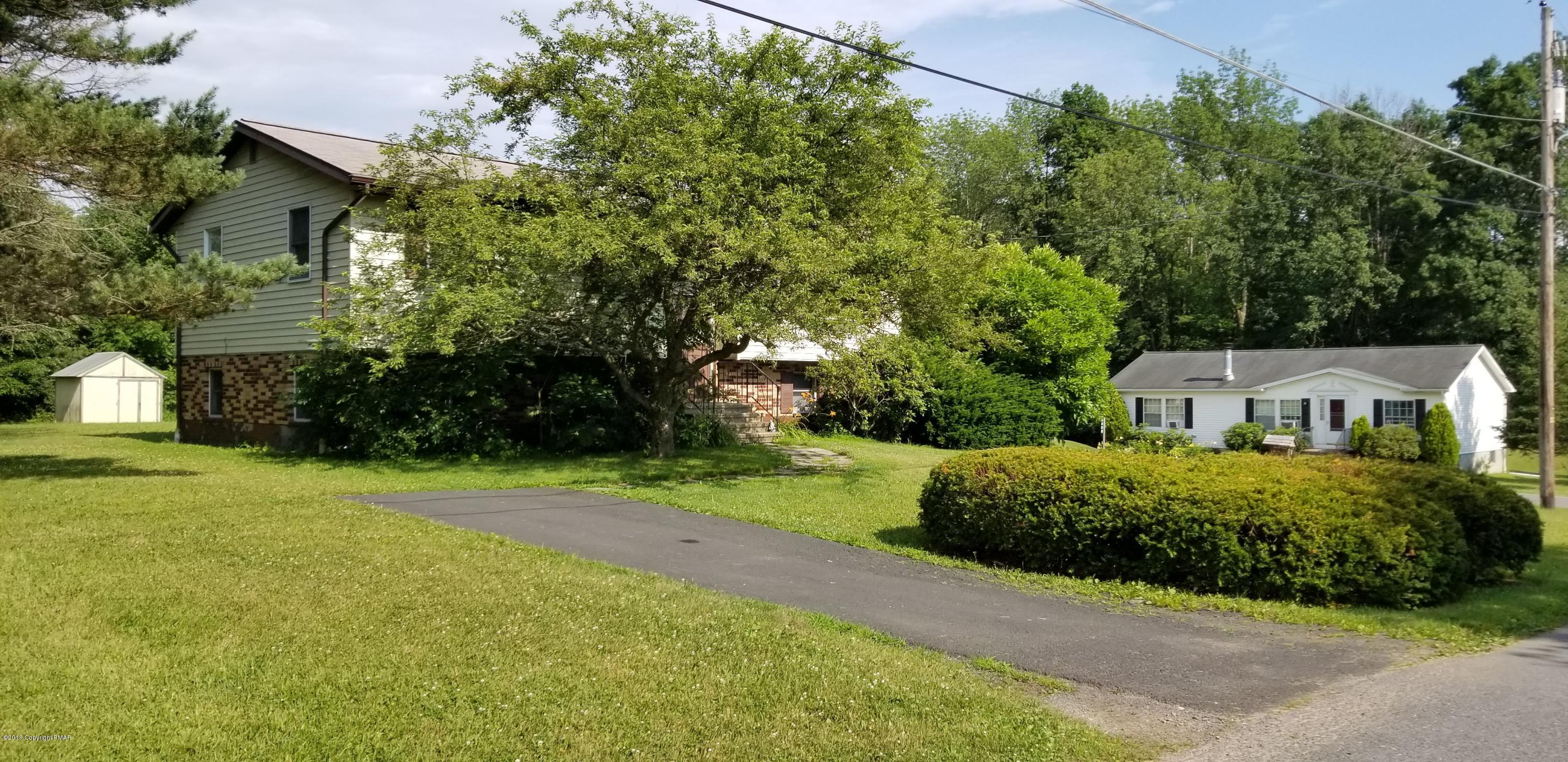 3401 Walnut Road Kunkletown, PA 18058 - Photo 3 of 25 a front view of a house with a yard and garage