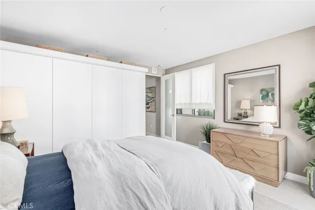 a bedroom with a large bed and a chandelier