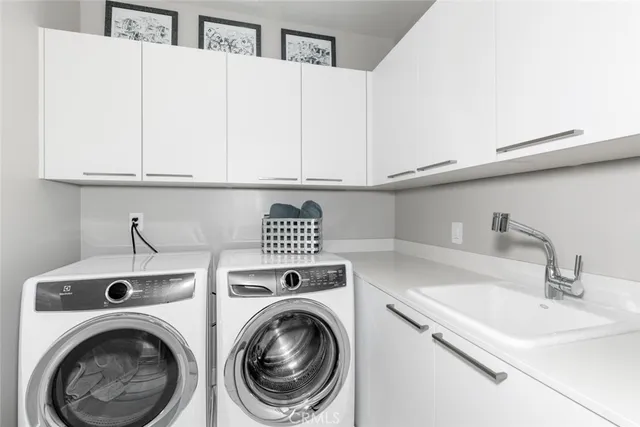 a view of a sink and washer dryer