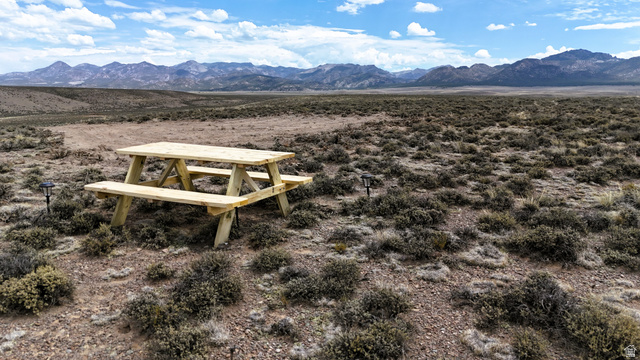 123 East Tbd 5000 Road North Panguitch, UT 84759 - Photo 1 of 54 Expansive natural landscape with a light wood picnic table and distant mountain ranges