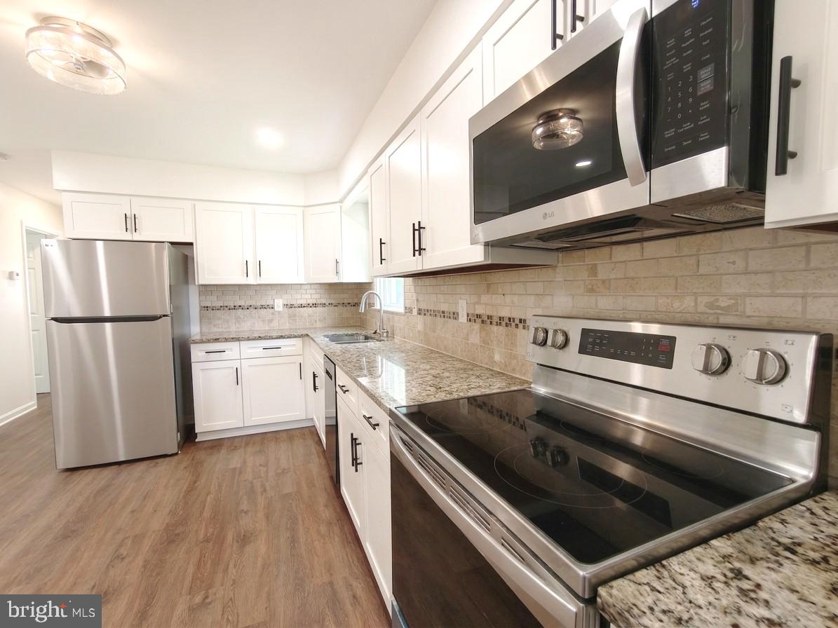 6066 Shady Side Road Shady Side, MD 20764 - Photo 17 of 61 Modern kitchen with sleek finishes.