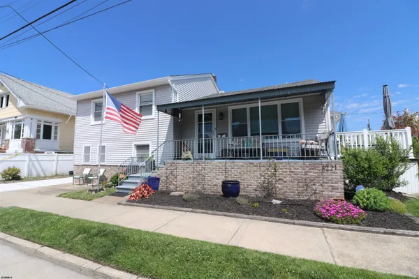 a front view of a house with sitting area
