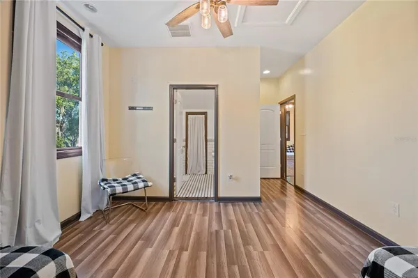 a bedroom with a bed and a flat tv screen on the dresser