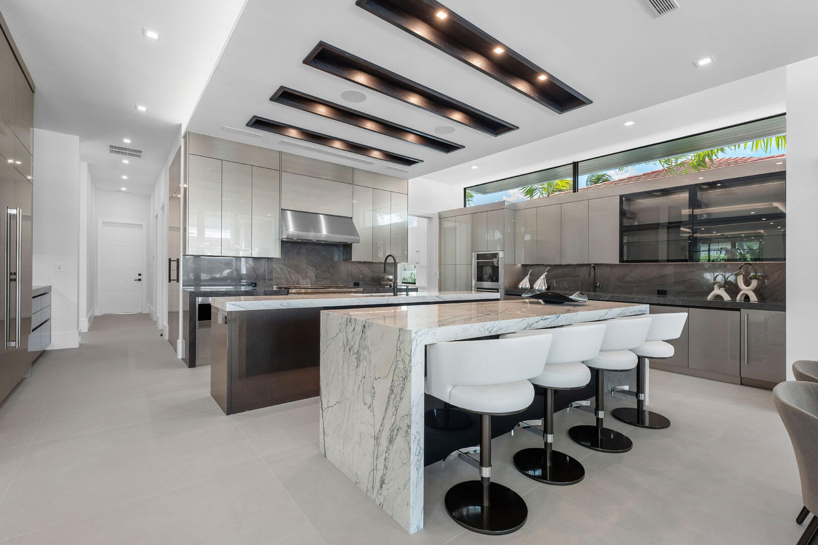 169 Coconut Palm Road Boca Raton, FL 33432 - Photo 17 of 84 a large white kitchen with a sink and cabinets