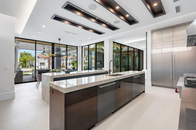 a front view of a house with a yard and potted plants