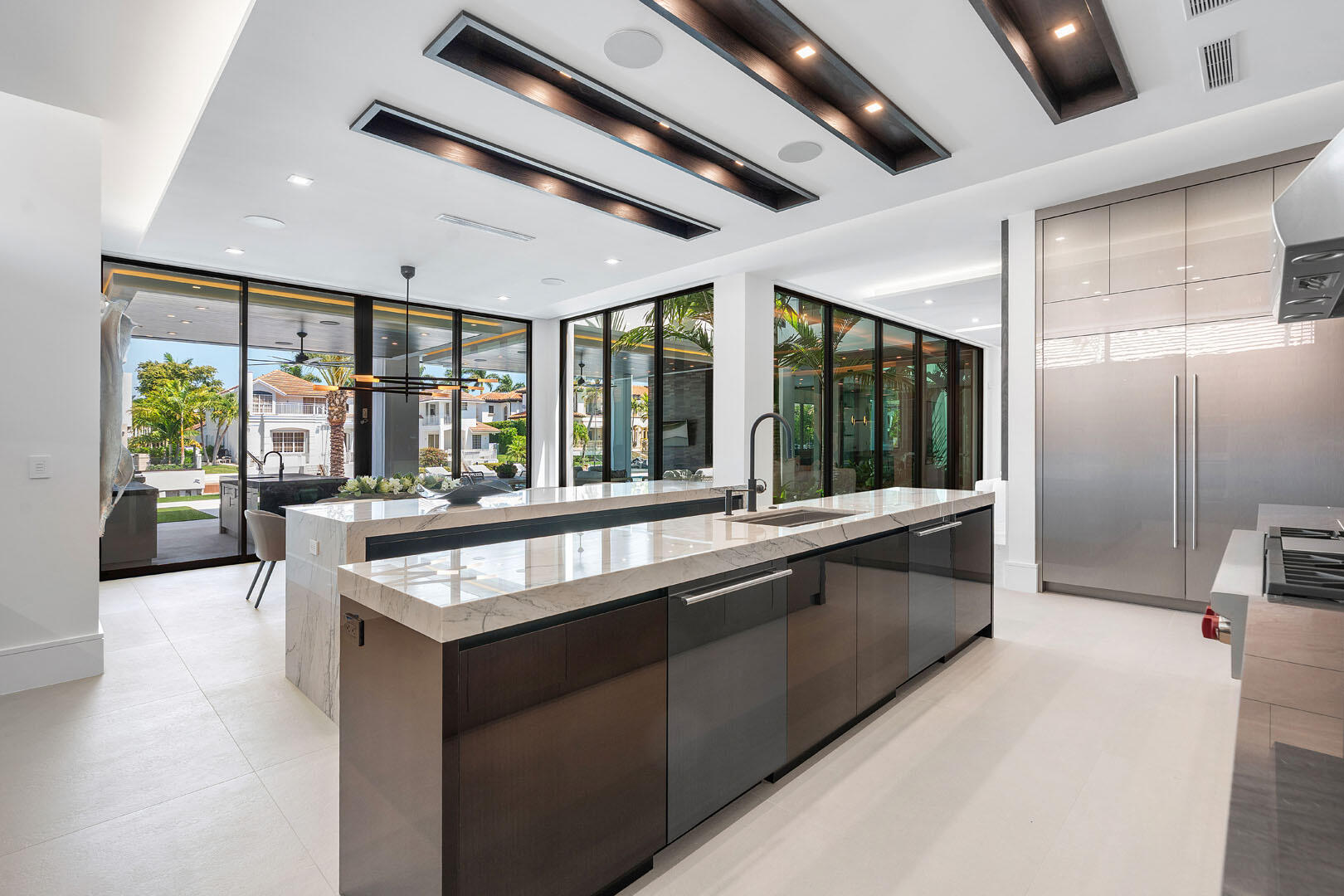 169 Coconut Palm Road Boca Raton, FL 33432 - Photo 18 of 84 a large kitchen with granite countertop a large window and stainless steel appliances