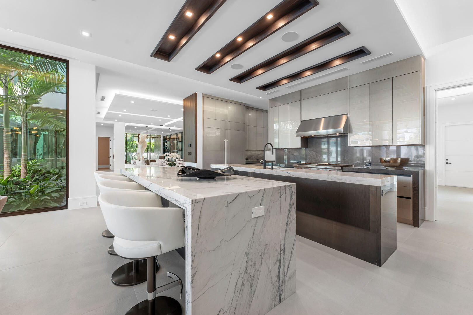 169 Coconut Palm Road Boca Raton, FL 33432 - Photo 20 of 84 a kitchen with kitchen island granite countertop lots of counter top space and stainless steel appliances