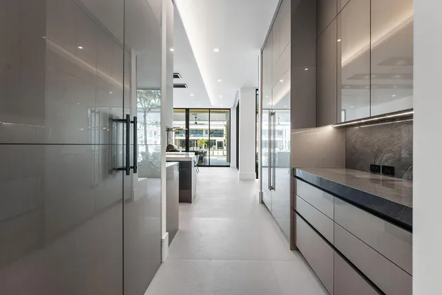 a room with stainless steel appliances kitchen island granite countertop furniture and a flat screen tv