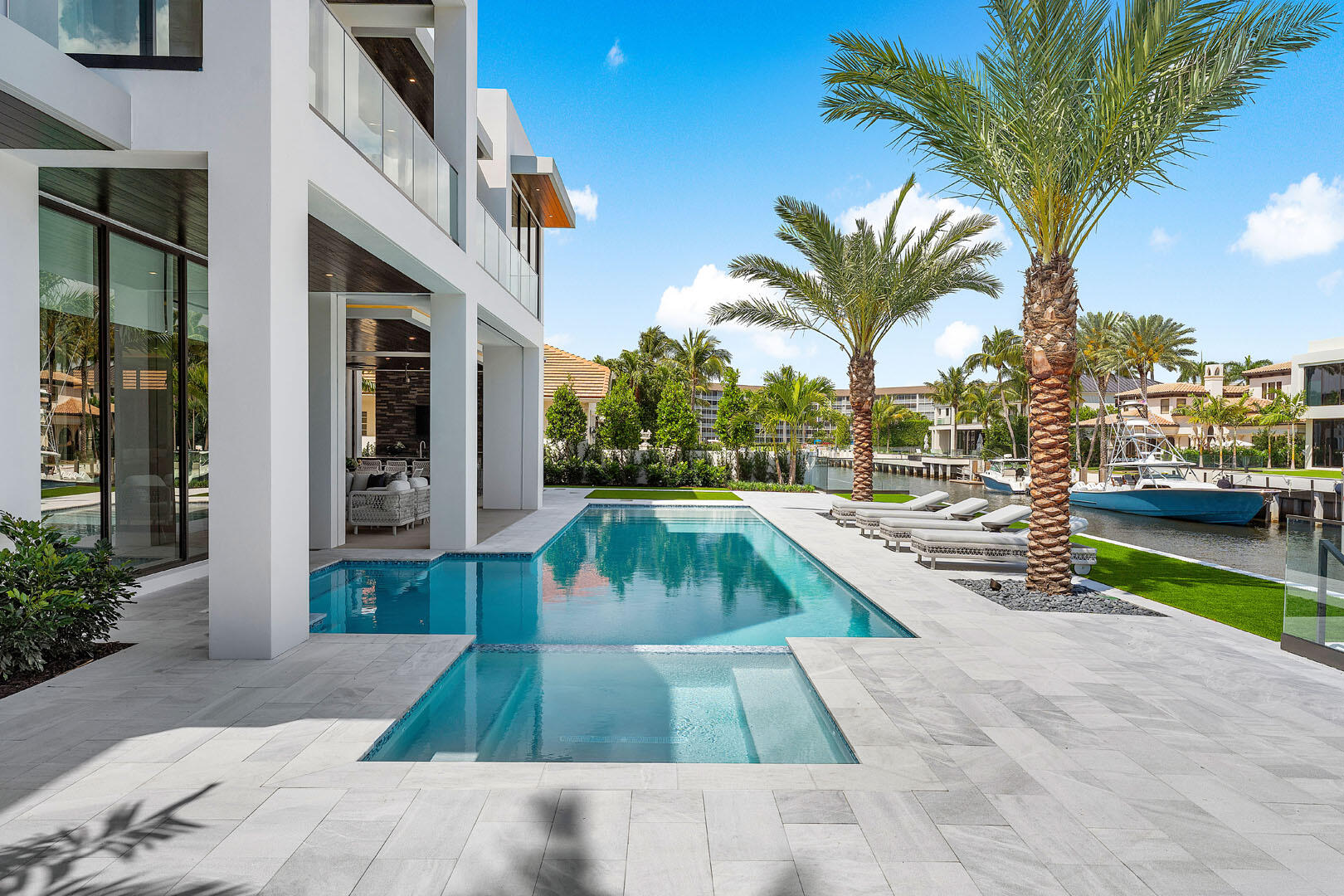 169 Coconut Palm Road Boca Raton, FL 33432 - Photo 29 of 84 a view of a swimming pool with a lounge chairs
