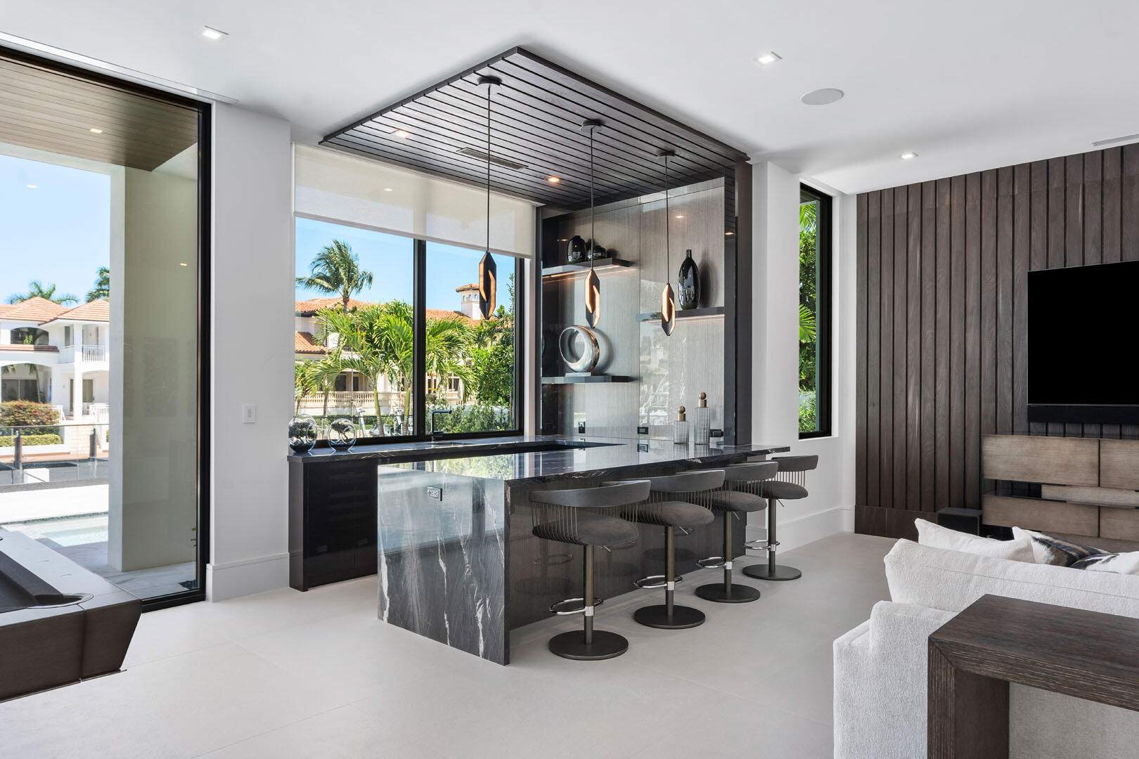 169 Coconut Palm Road Boca Raton, FL 33432 - Photo 33 of 84 a room with stainless steel appliances kitchen island granite countertop furniture and a flat screen tv