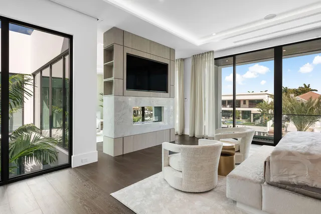 a dining room with furniture and large windows