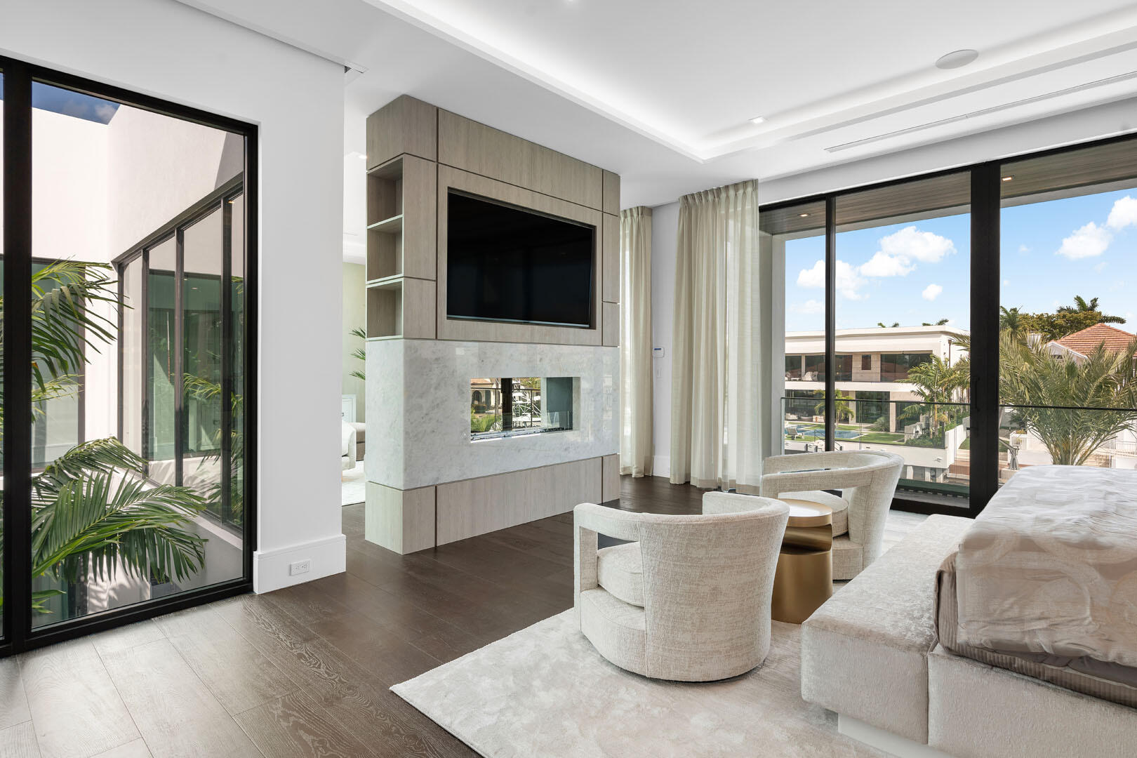 169 Coconut Palm Road Boca Raton, FL 33432 - Photo 40 of 84 a living room with furniture a flat screen tv and a floor to ceiling window