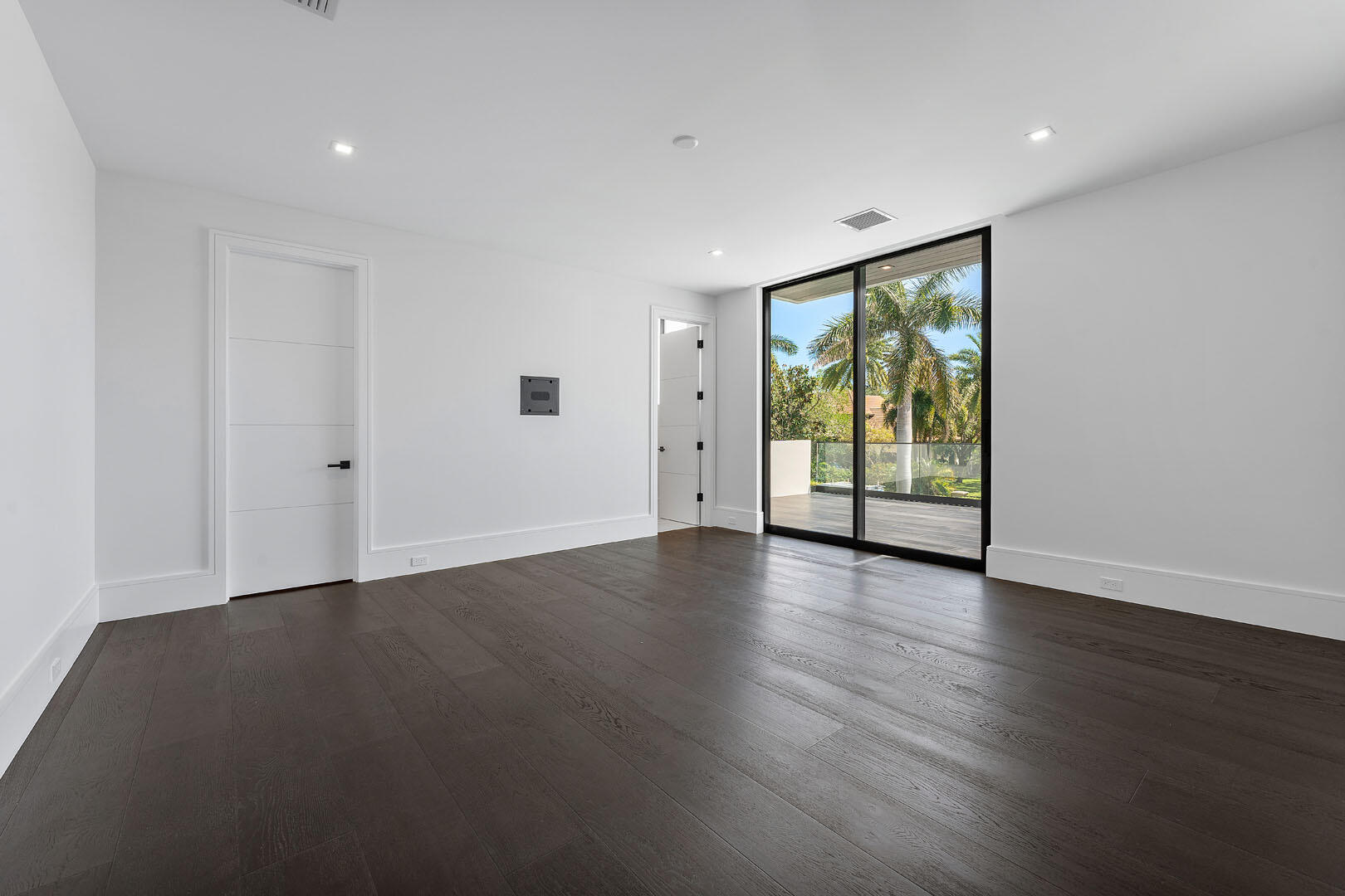 169 Coconut Palm Road Boca Raton, FL 33432 - Photo 54 of 84 a view of an empty room with wooden floor and a window
