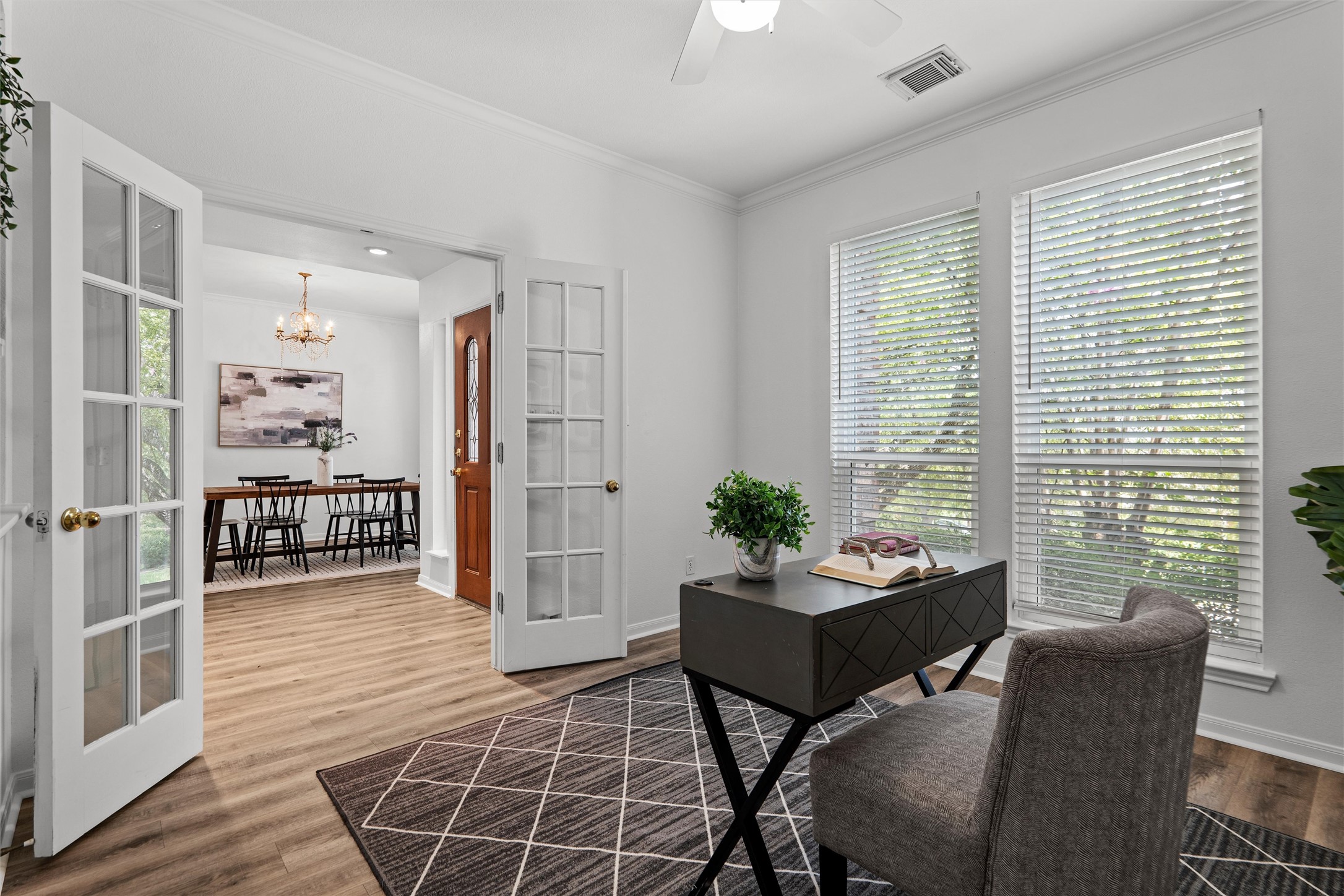 7000 Colberg Court Austin, TX 78749 - Photo 6 of 40 French doors open into a bright study with wood flooring, offering a quiet workspace.