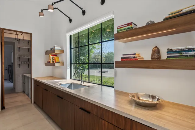 a bathroom with a granite countertop toilet sink and mirror