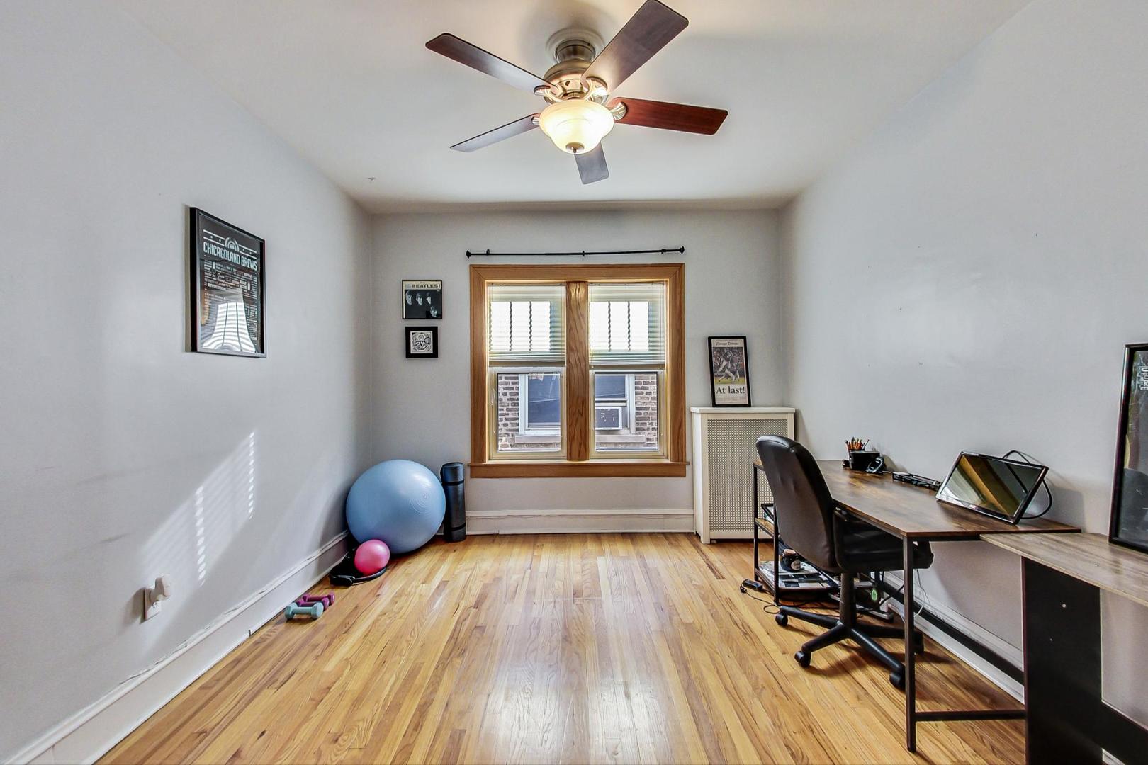 537 West Addison Street, Unit 3S Chicago, IL 60613 - Photo 13 of 19 a workspace with wooden floor and a window