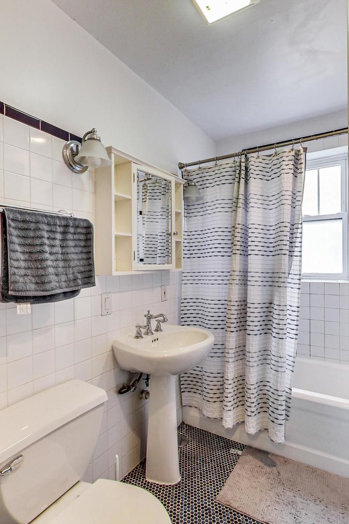 537 West Addison Street, Unit 3S Chicago, IL 60613 - Photo 16 of 19 a bathroom with a sink toilet and shower