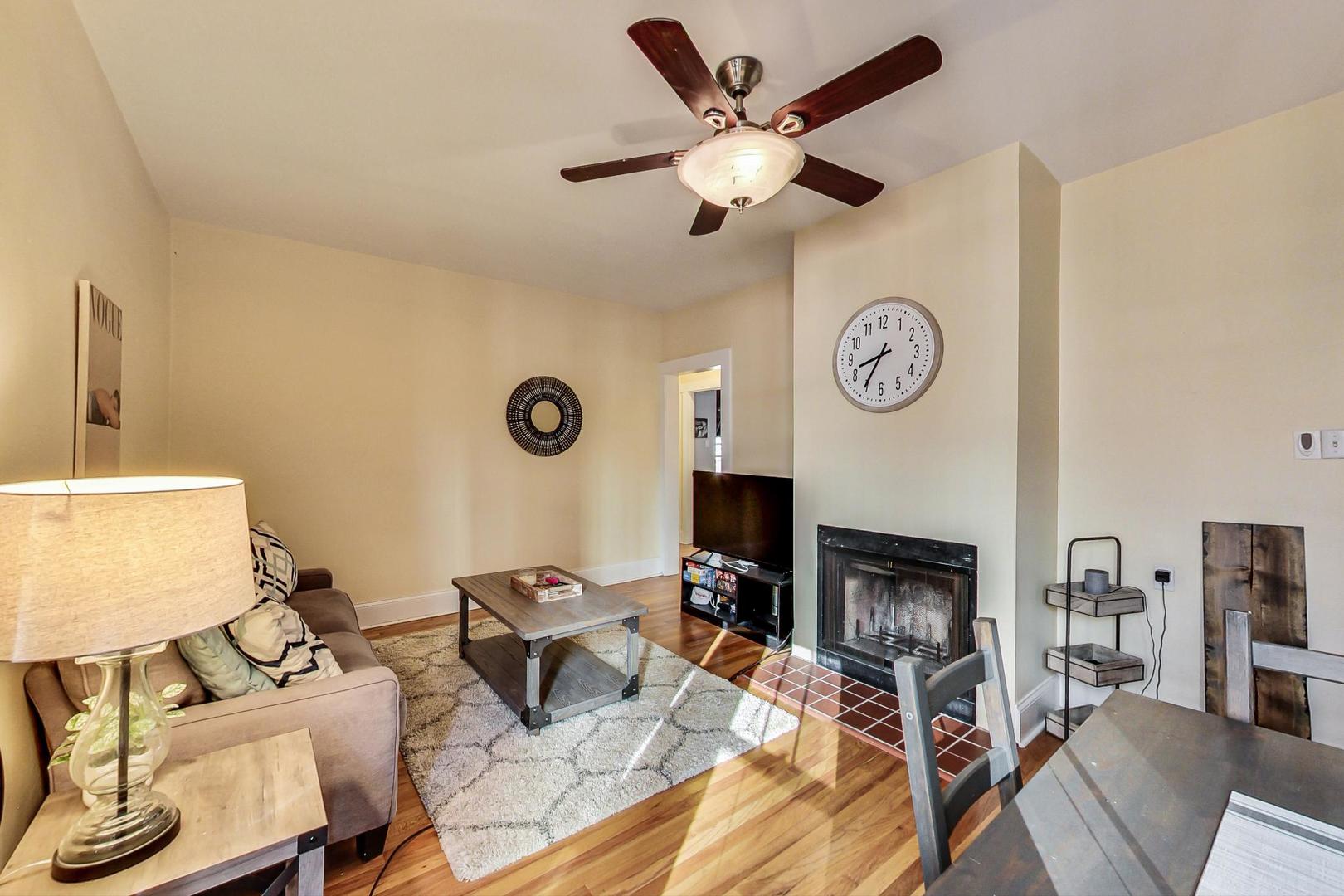 537 West Addison Street, Unit 3S Chicago, IL 60613 - Photo 4 of 19 a living room with furniture a fireplace and a large window