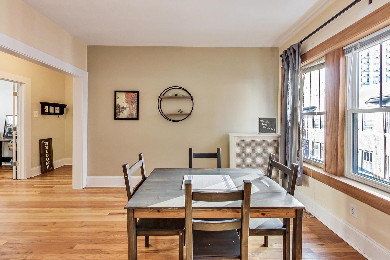 537 West Addison Street, Unit 3S Chicago, IL 60613 - Photo 5 of 19 a view of a dining room with furniture window and wooden floor