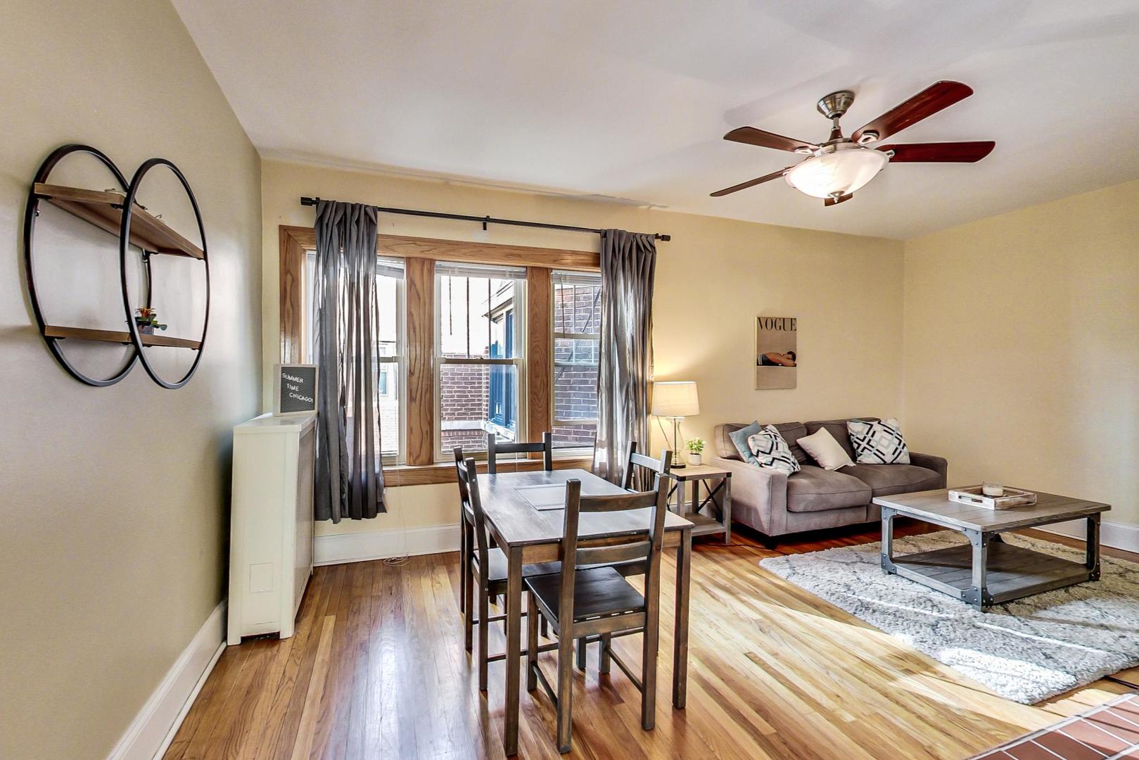 537 West Addison Street, Unit 3S Chicago, IL 60613 - Photo 6 of 19 a living room with furniture a window and a chandelier