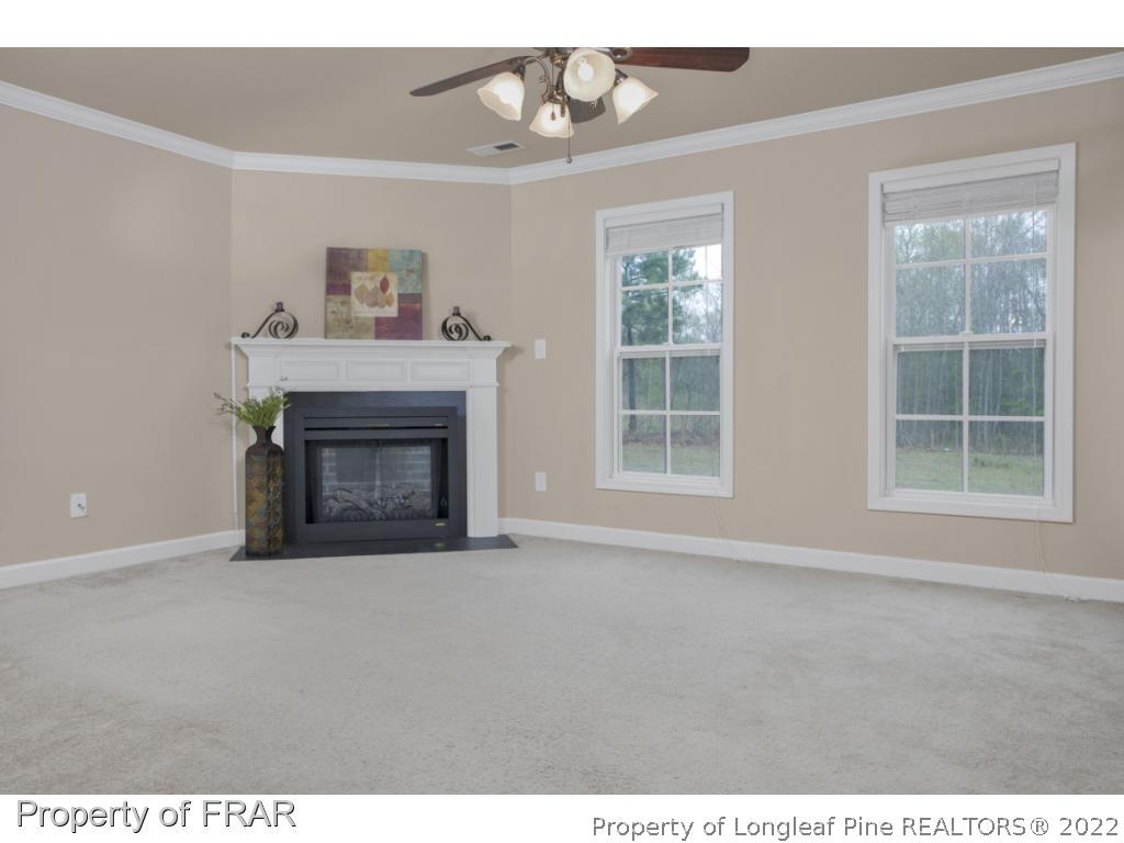363 United Road Raeford, NC 28376 - Photo 8 of 34 a view of an empty room with a fireplace and a window