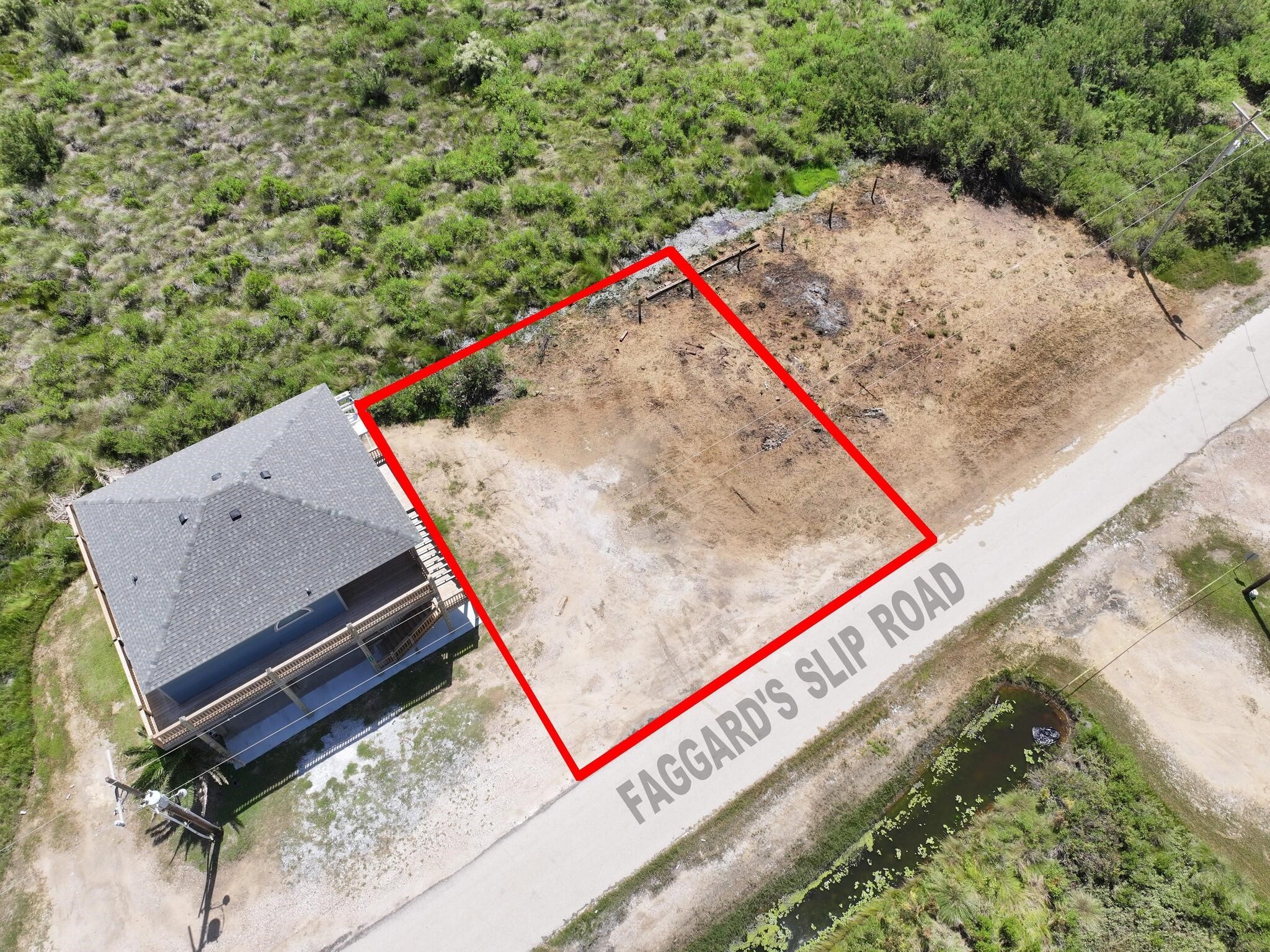 21 Faggards Road Port Bolivar, TX 77650 - Photo 2 of 13 a view of a backyard with wooden fence