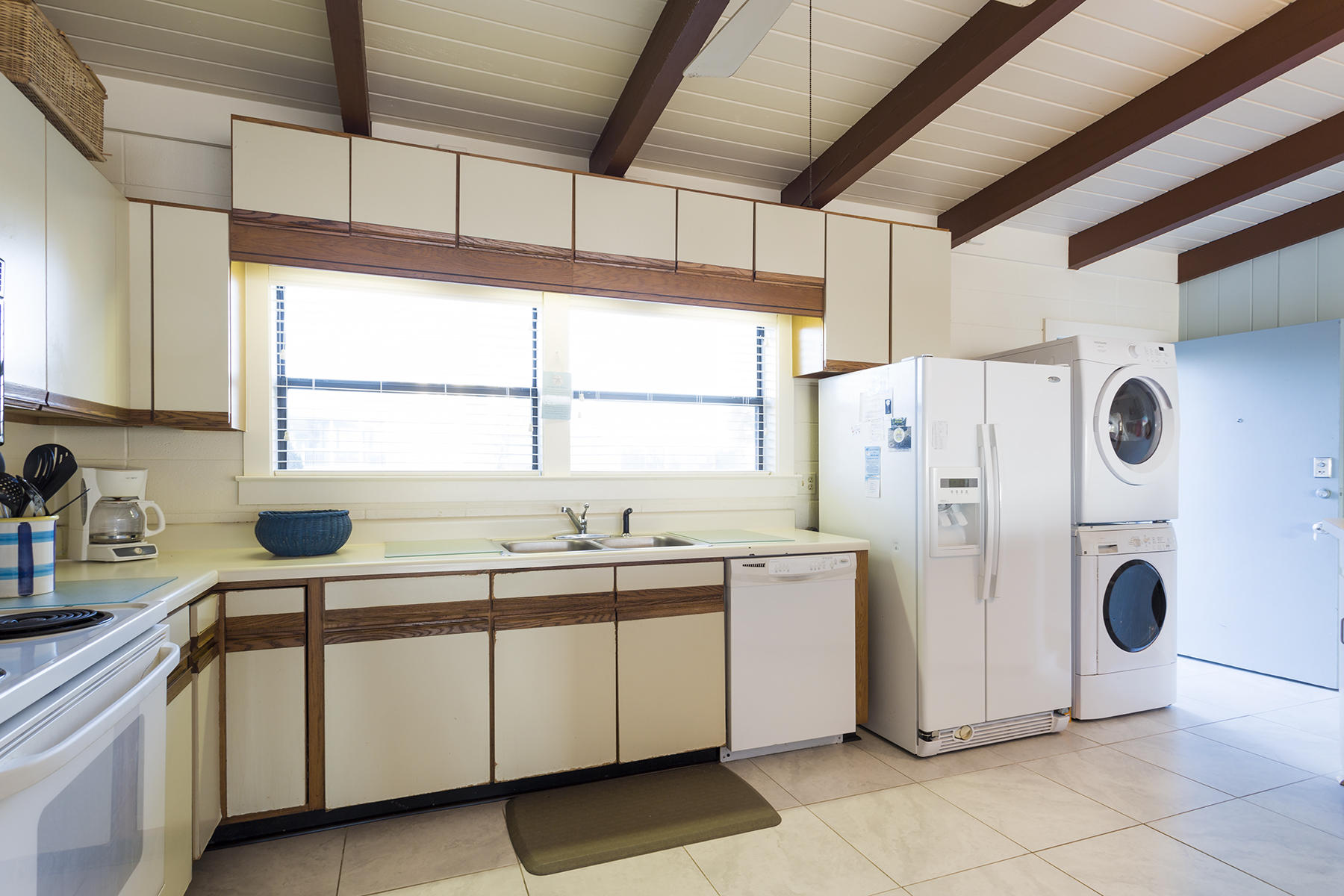 644 Blue Mountain Road Santa Rosa Beach, FL 32459 - Photo 7 of 17 a kitchen with a sink a refrigerator and window
