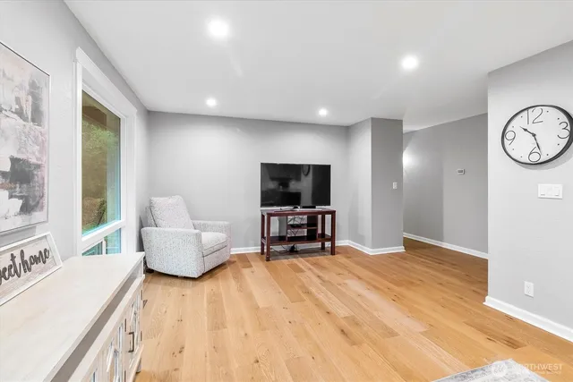 a dining room with furniture a rug and wooden floor