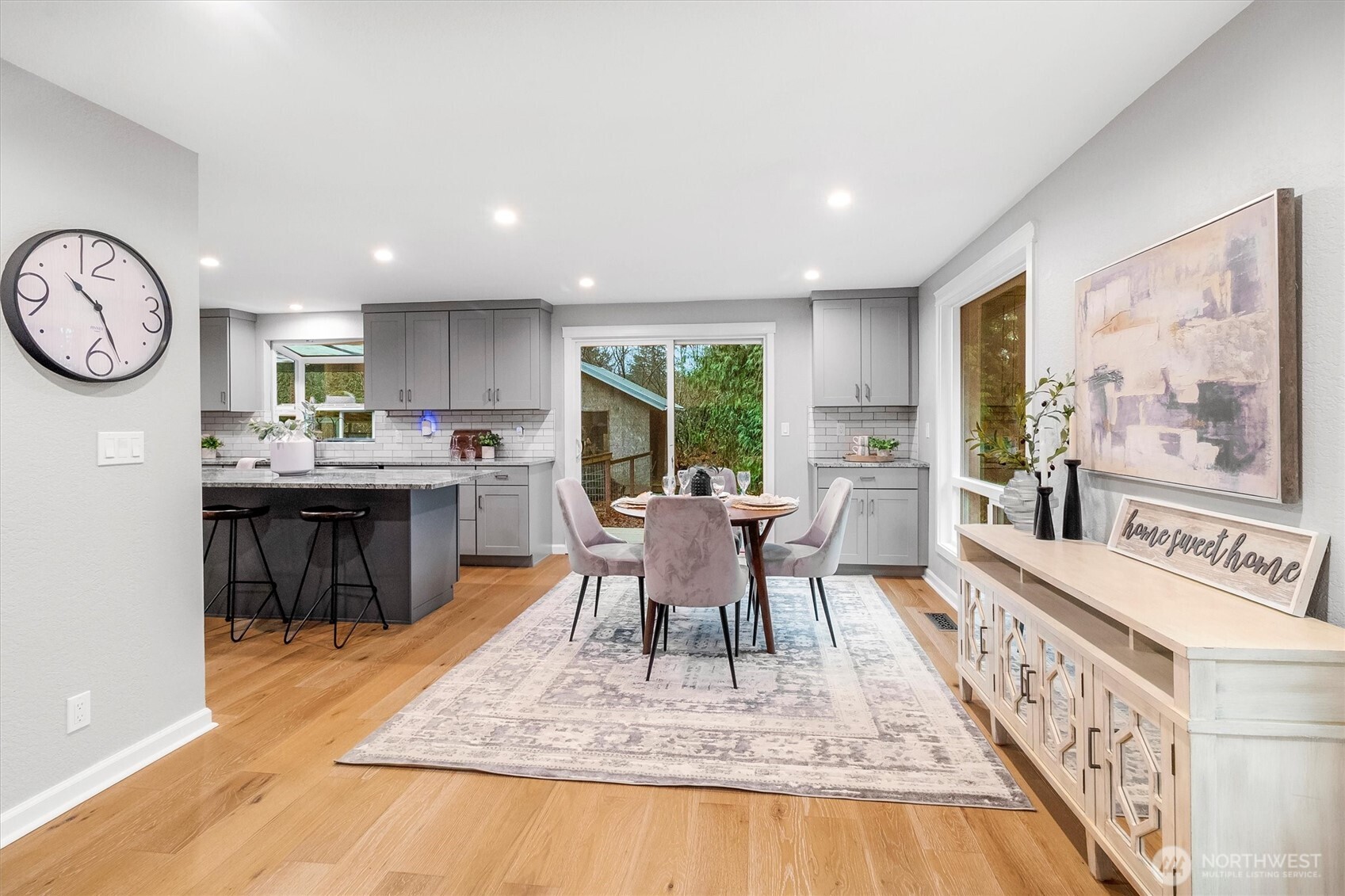 299 Friday Creek Road Bellingham, WA 98229 - Photo 9 of 36 a dining room with furniture a rug and wooden floor