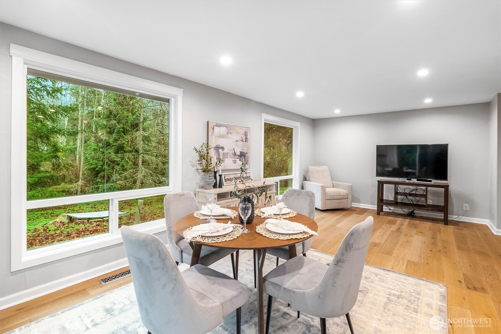 299 Friday Creek Road Bellingham, WA 98229 - Photo 10 of 36 a living room with furniture a flat screen tv and a floor to ceiling window