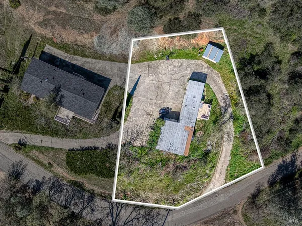 an aerial view of a house with a yard
