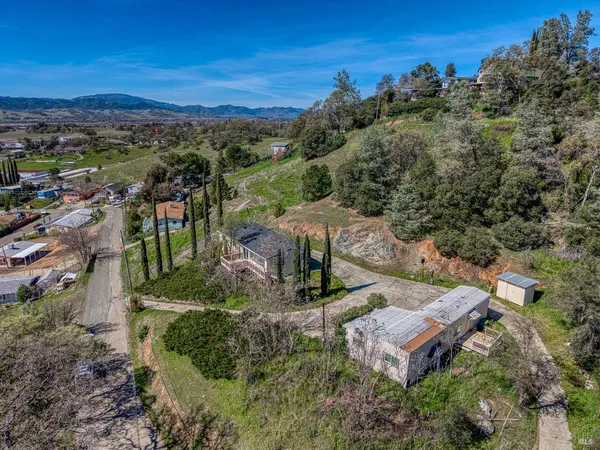 an aerial view of a house with mountain view