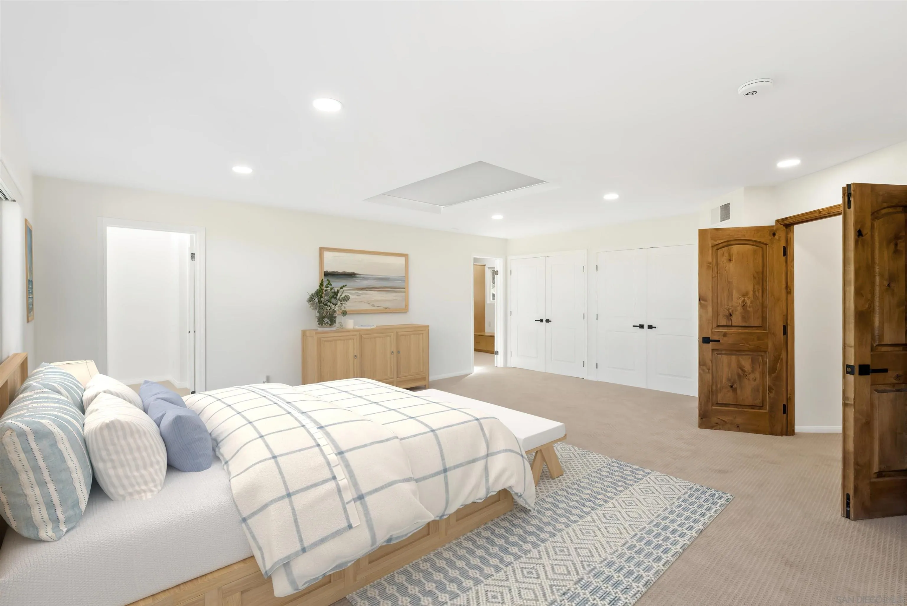 13404 Kibbings Road San Diego, CA 92130 - Photo 16 of 32 a bedroom with a bed and a large mirror