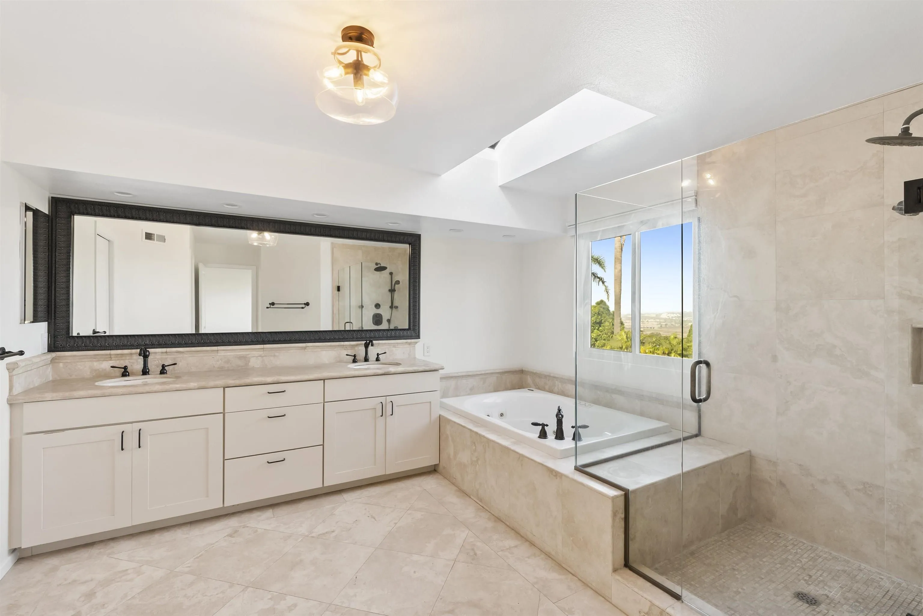 13404 Kibbings Road San Diego, CA 92130 - Photo 20 of 32 a bathroom with a tub sink and mirror