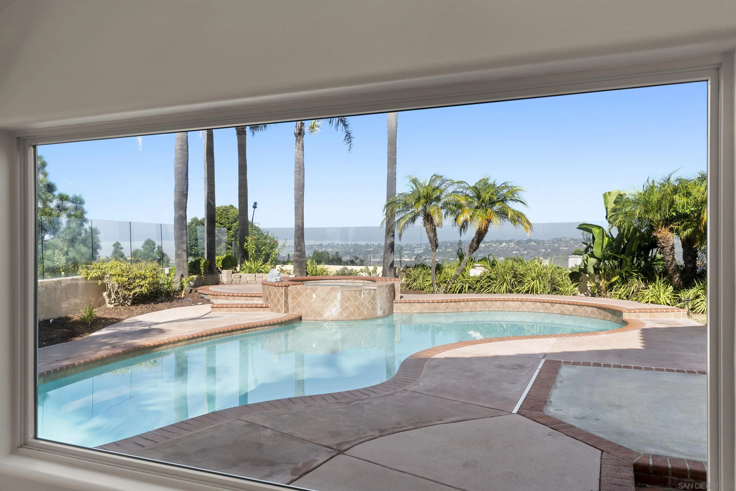 13404 Kibbings Road San Diego, CA 92130 - Photo 23 of 32 a view of a living room and floor to ceiling window and yard