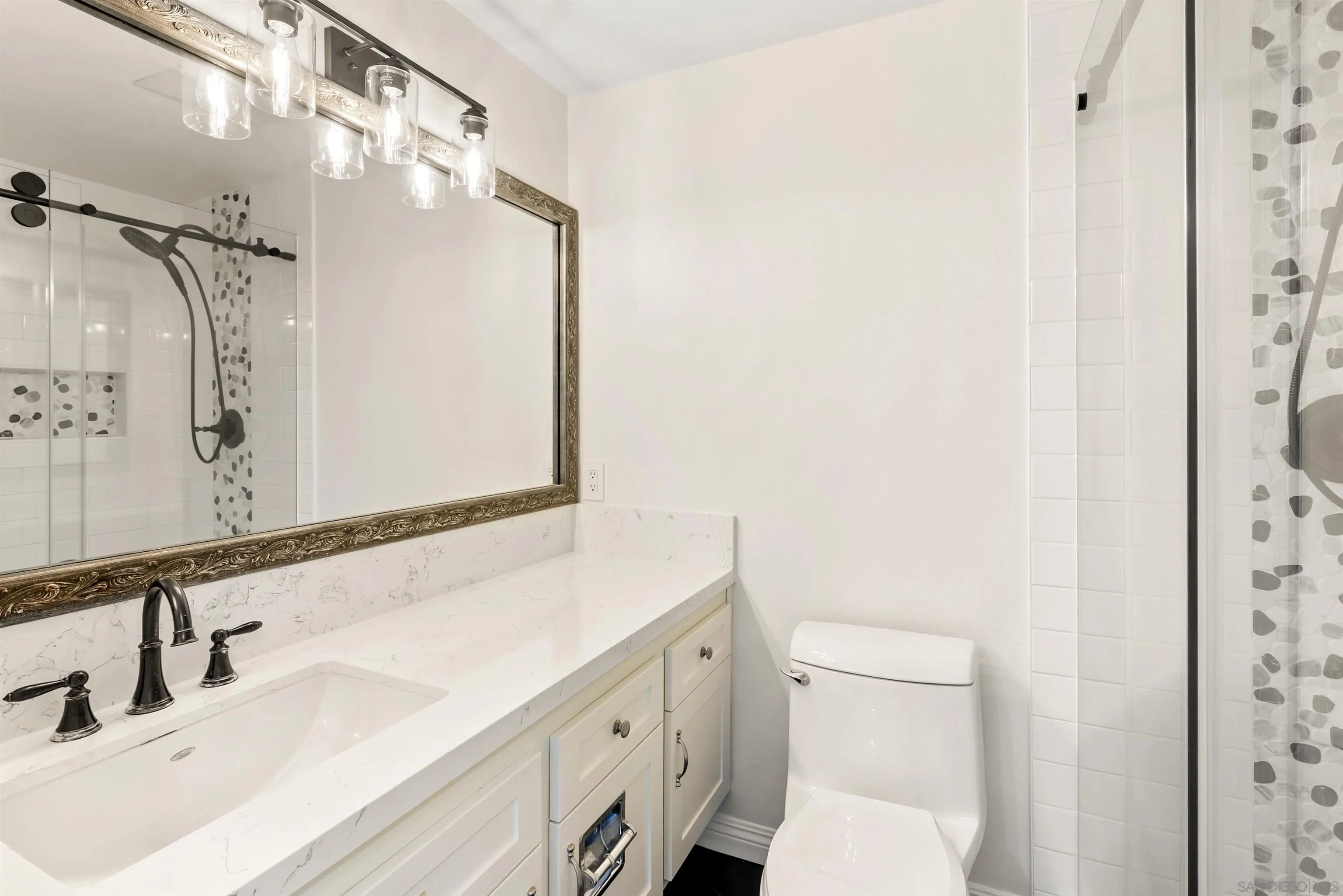 13404 Kibbings Road San Diego, CA 92130 - Photo 25 of 32 a bathroom with a sink vanity mirror and toilet