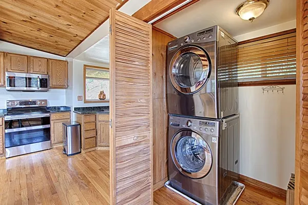 a view of washer and dryer with kitchen in the background