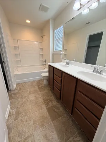 a bathroom with a sink a mirror and a bathtub