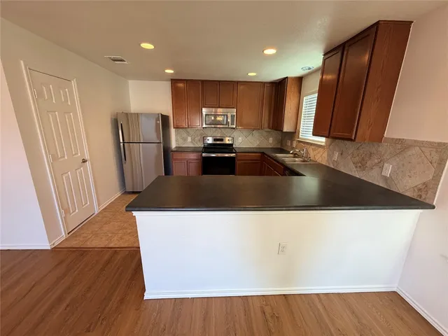 a view of a living room with wooden floor
