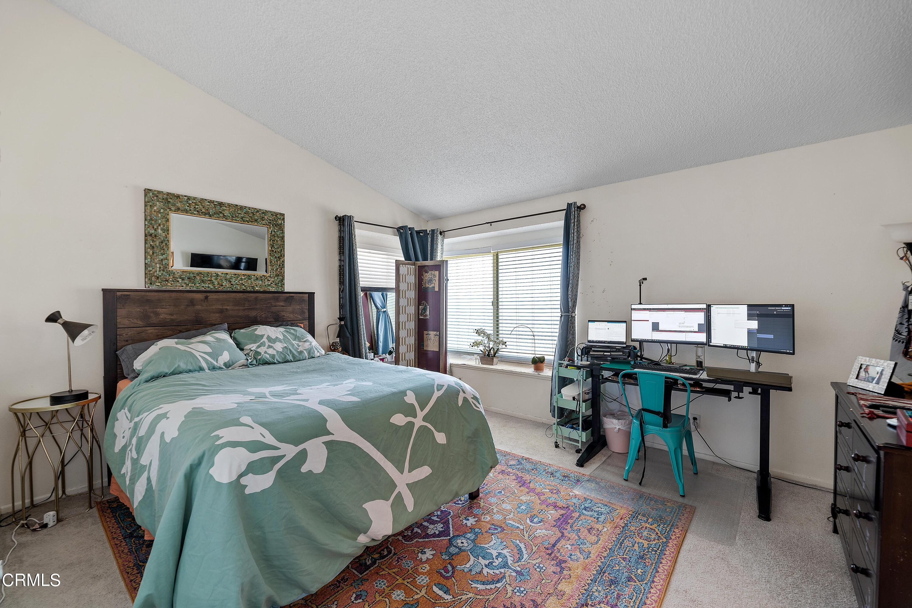 5319 Perkins Road Oxnard, CA 93033 - Photo 19 of 24 a bed sitting in a bedroom next to a window with chair and table