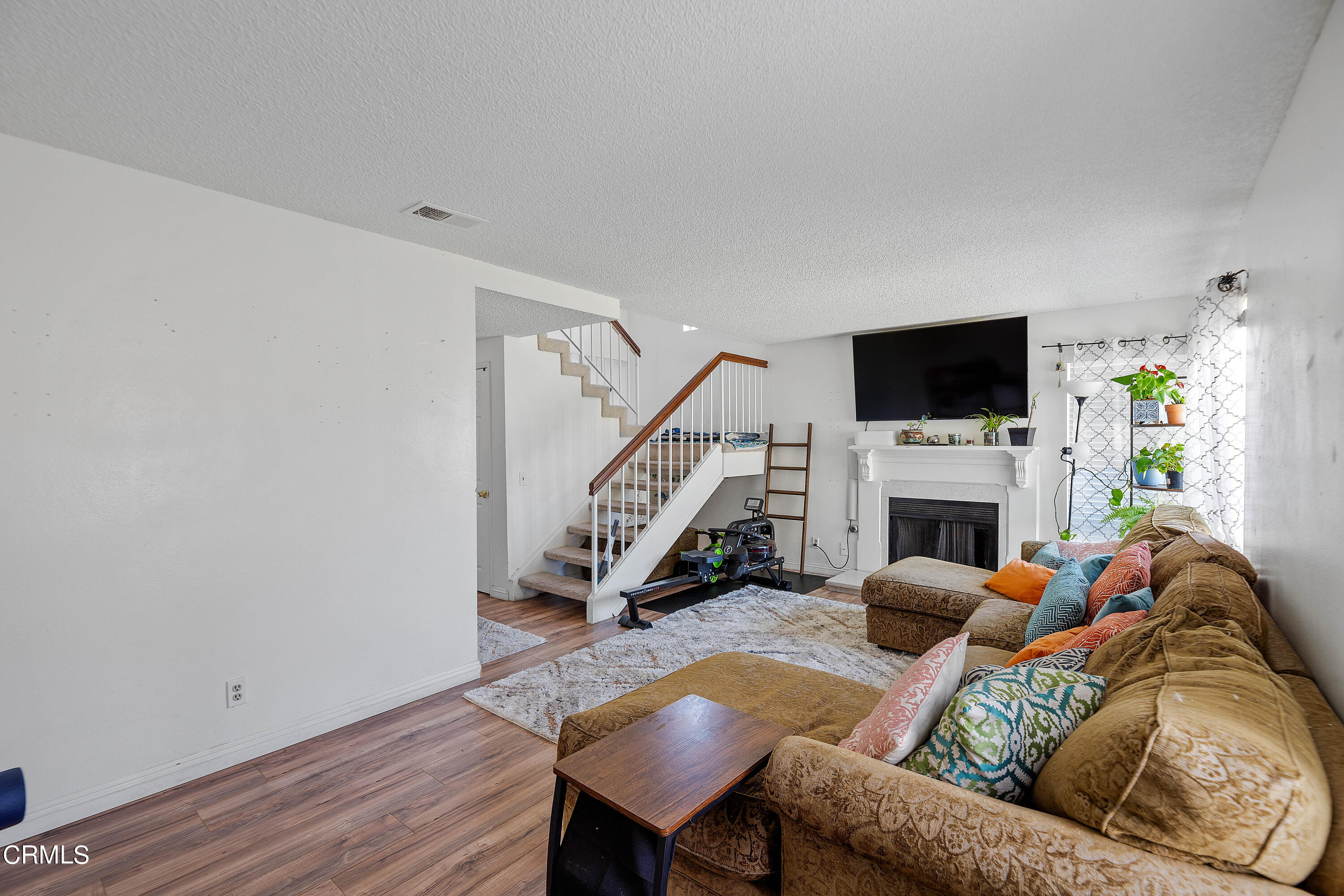5319 Perkins Road Oxnard, CA 93033 - Photo 4 of 24 a living room with furniture a fireplace and a flat screen tv