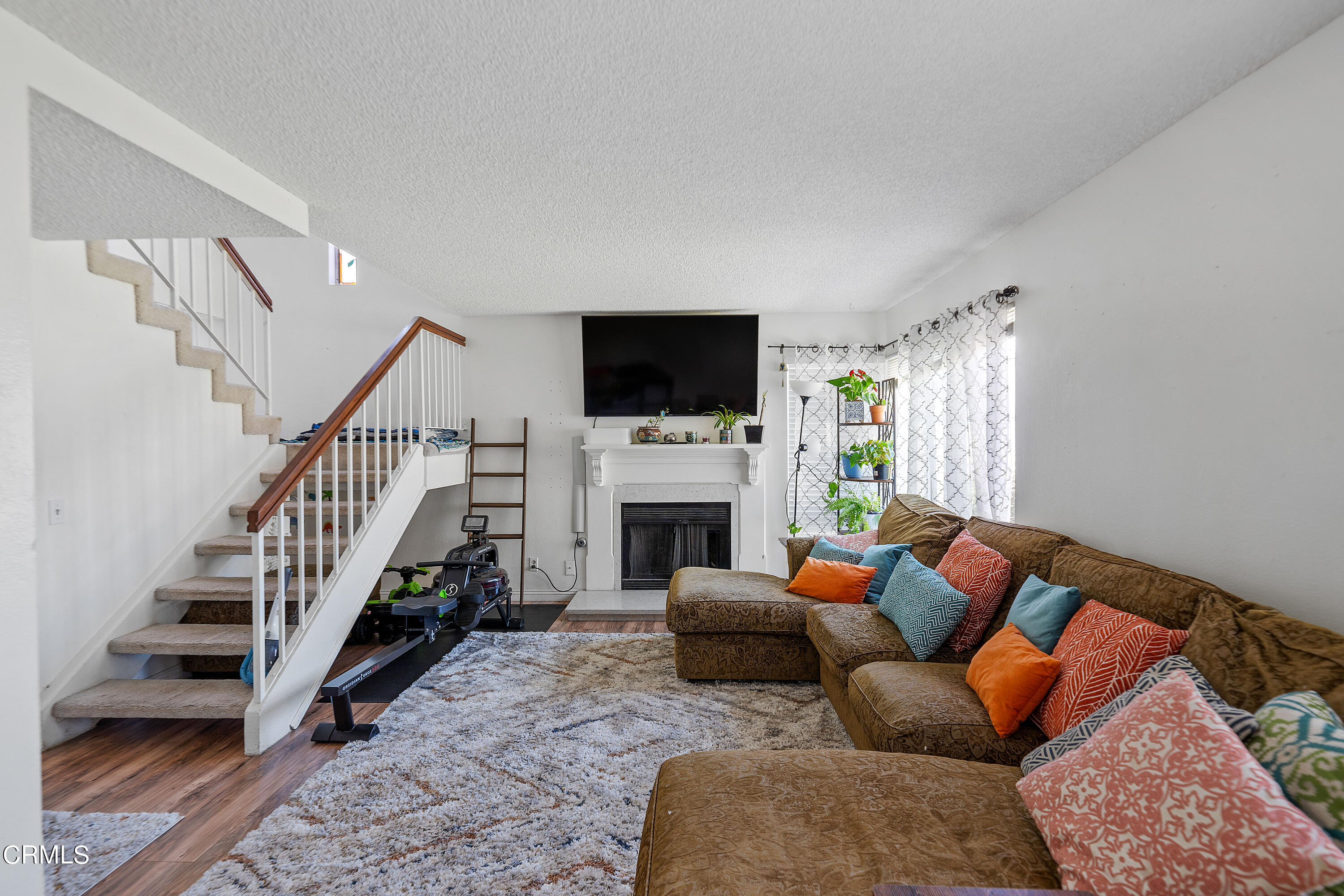 5319 Perkins Road Oxnard, CA 93033 - Photo 5 of 24 a living room with furniture a fireplace and a flat screen tv