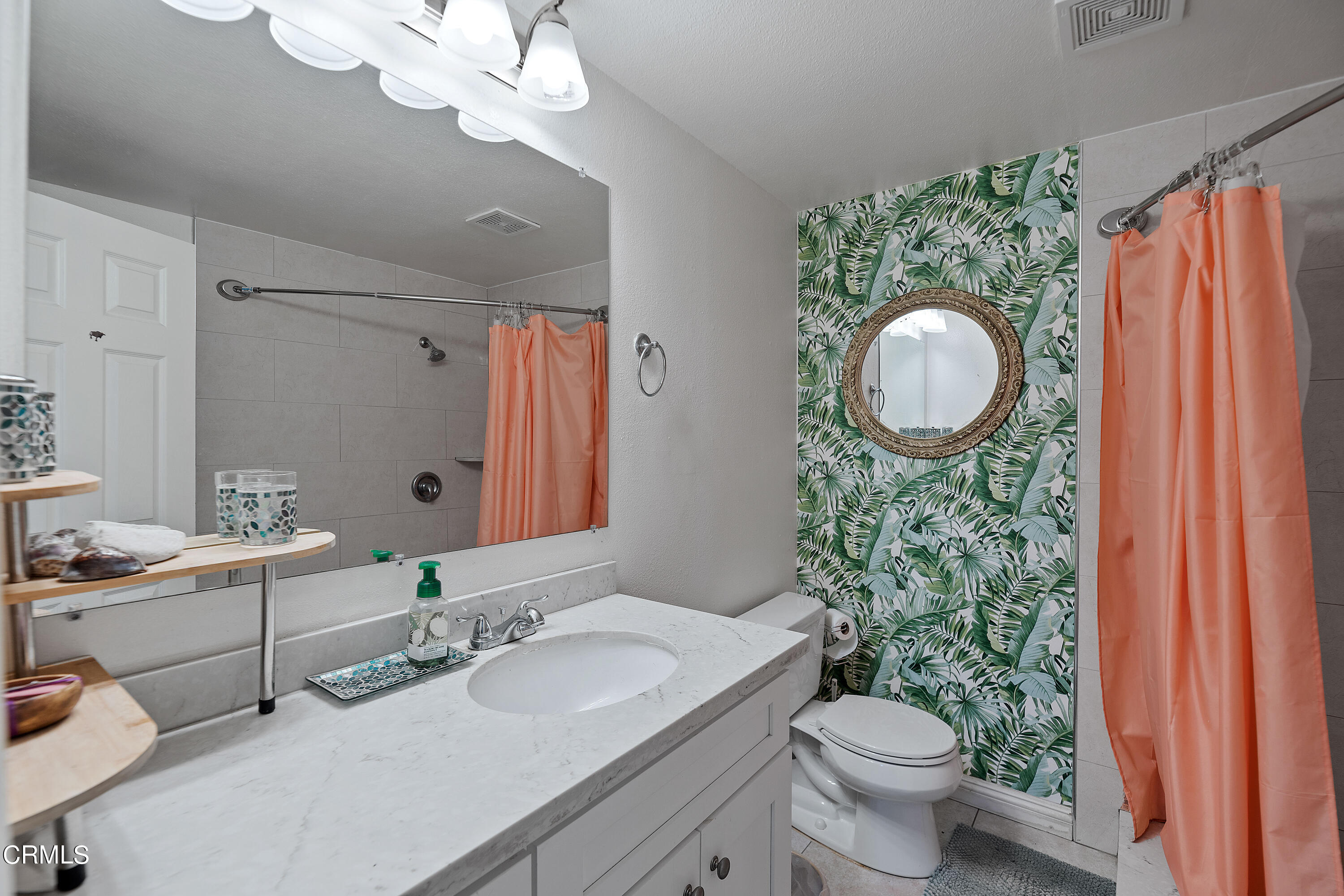 5319 Perkins Road Oxnard, CA 93033 - Photo 9 of 24 a bathroom with a granite countertop sink a toilet and a mirror