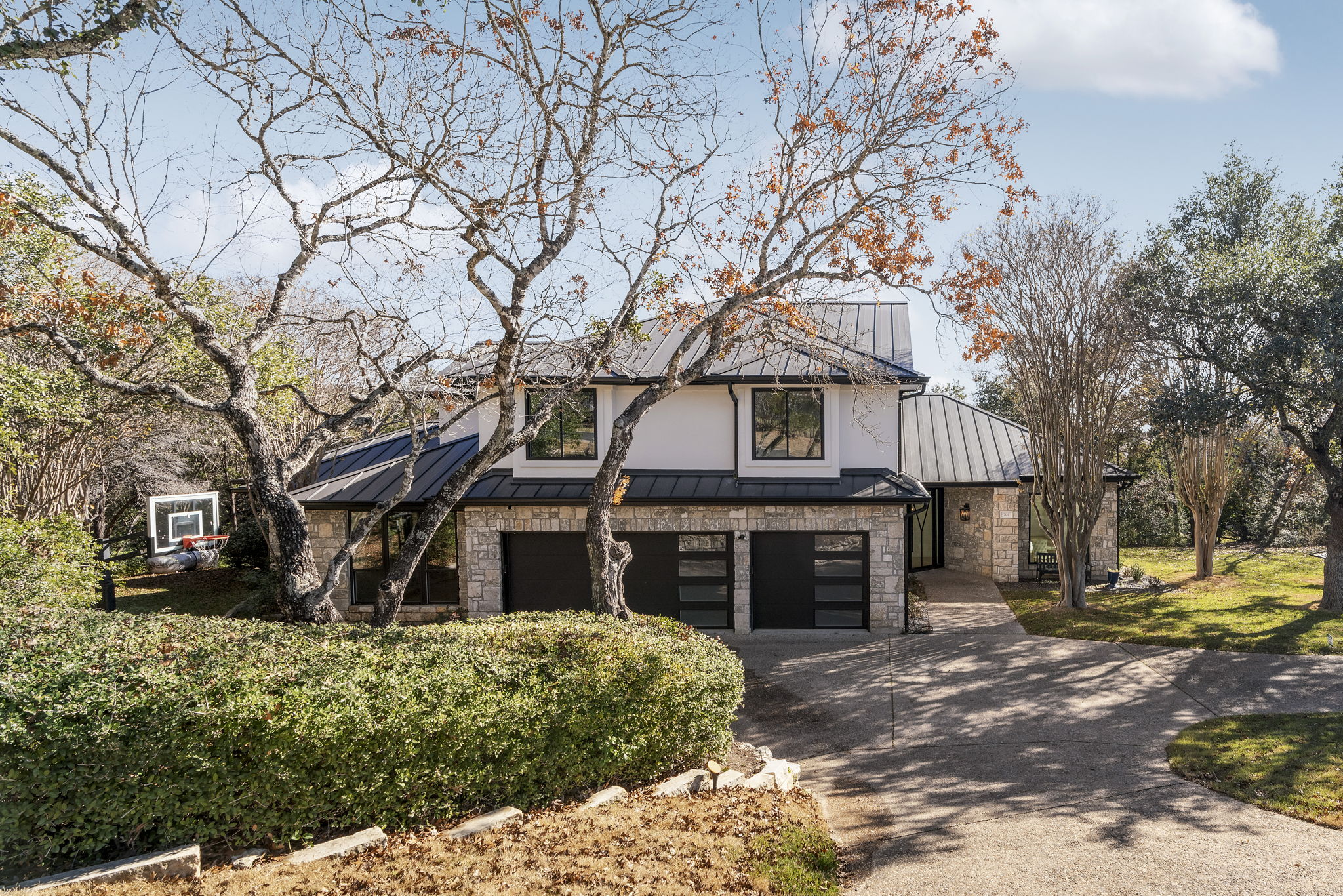 701 Furlong Drive Austin, TX 78746 - Photo 4 of 40 a front view of a house with a yard
